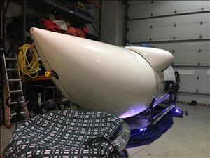 A white submersible inside a garage